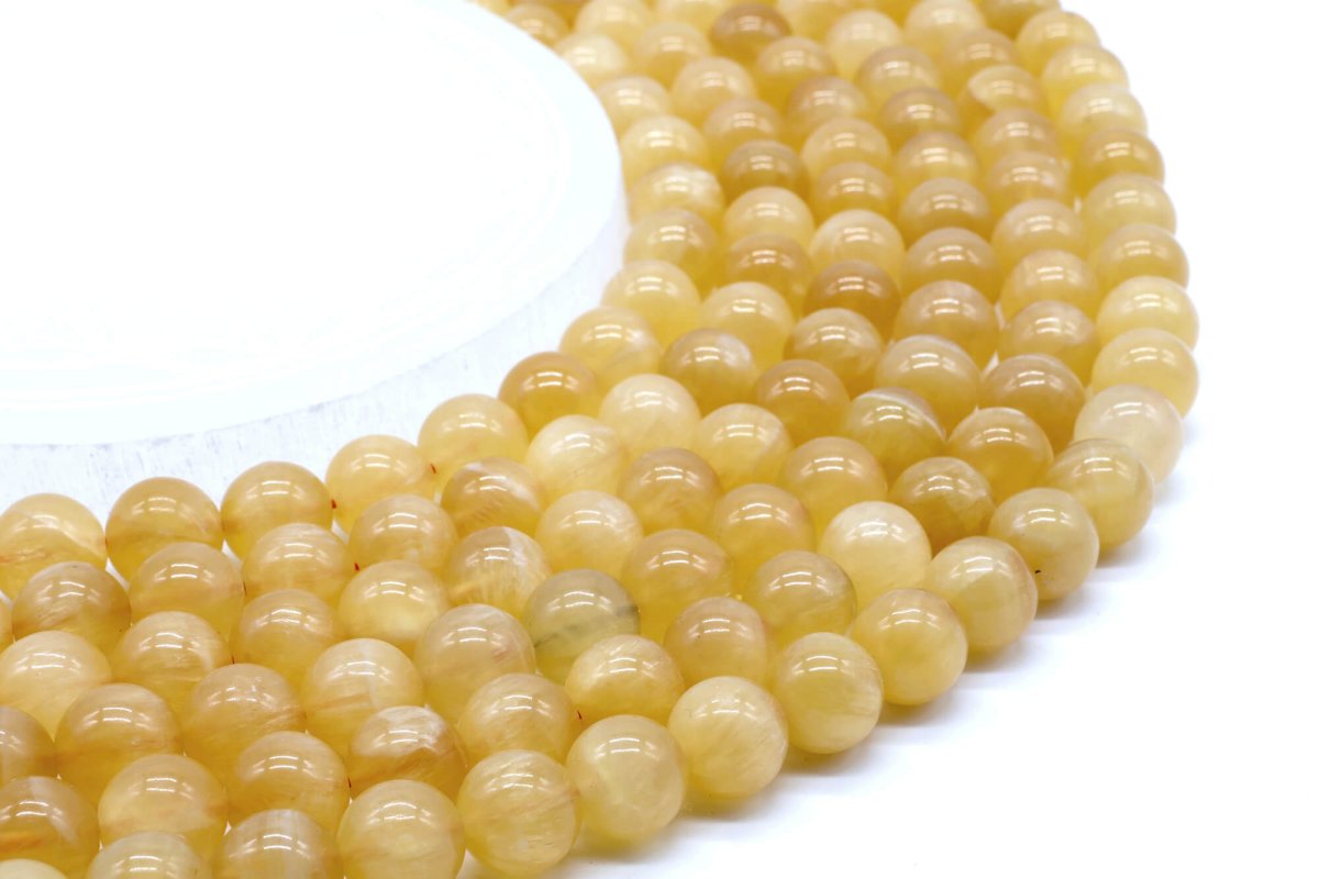 Perle di calcite arancione 10 mm su un filo di 40 cm