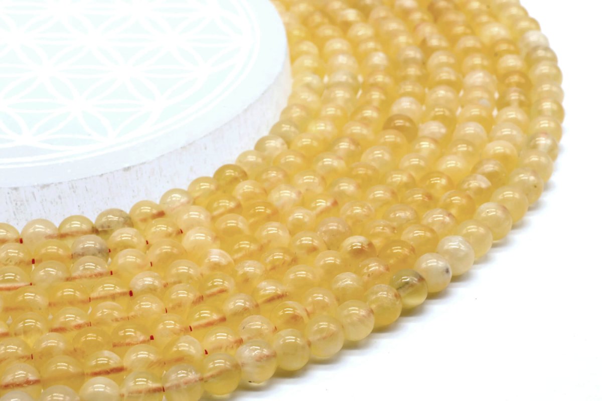 Perle di calcite arancione 6 mm su un filo di 40 cm