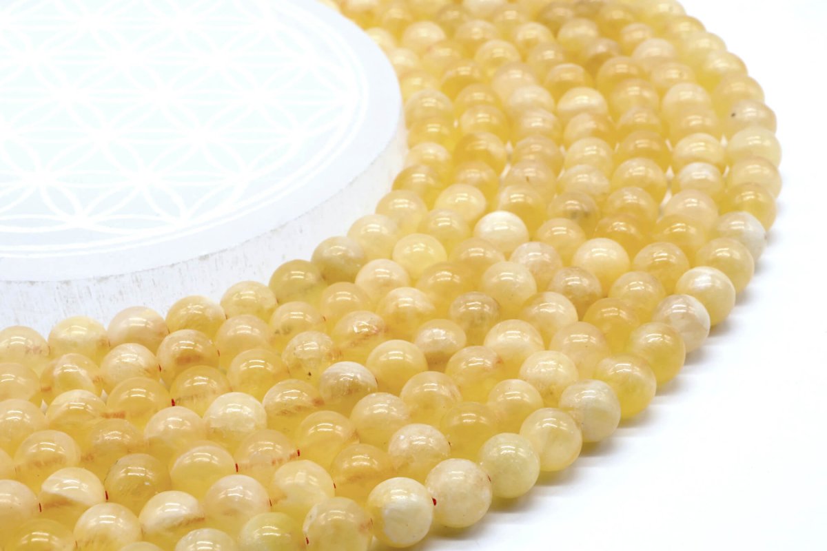 Perle di calcite arancione 8 mm su un filo di 40 cm